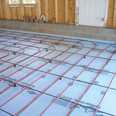 an unfinished floor with red piping lines on it