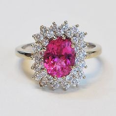 ... ORIGINAL PRICE $2950.00, SALE PRICE $1475.00...This stunning handmade oval pink tourmaline and diamond ring is set in 14k white gold. This ring sparkles a great deal making this a beautiful piece. The two rows of diamonds around the pink tourmaline make for a generous frame that fits this stone magnificently and really shows off its brilliant pink color. This ring would make for a great engagement ring, or right hand ring. Pink Tourmaline: 1.87ct32 Round Brilliant Diamonds: 1 ct VS/G-HRing S Luxury Pink Gemstone With Center Stone, Classic Pink Gemstones For Formal Occasions, Elegant Round Pink Sapphire Gemstones, Luxury Pink Gemstones For Wedding, Pink Diamond Gemstones With Accents, Luxury Tourmaline Jewelry With Halo Setting, Pink Gemstones For Formal Occasions, Pink Gemstones With Prong Setting For Formal Occasions, Pink Gemstones For Formal Fine Jewelry