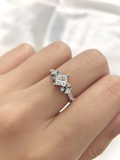 a woman's hand with a diamond ring on it