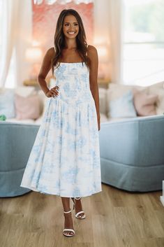 This stylish midi features adjustable straps and a smocked bodice. This is the perfect summertime dress! Fit: True to size, model is 5'6 wearing size small Summertime Dresses, White Dress Formal, Feather Tops, Summer Sundress, Beach Bridal, Top Graphic Tees, Blue Midi Dress, Semi Formal, Sundress