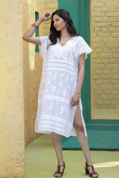 Whether you are relaxing at home strolling a beach boardwalk or sipping a spritz in an Italian cafe this cool and comfortable shift dress is just the ticket. Designed by India's Shalabh the deep v-neck dress features cap sleeves covered buttons on the bodice and traditional chikankari hand embroidery. Summer V-neck Tunic With Chikankari Embroidery, Casual Short Sleeve Resort Cover-up, Beachy Tunic For Spring Vacation, Short Sleeve Tunic For Beach And Summer, Casual Tunic Beach Dress, Summer Beach Tunic With Short Sleeves, Summer Daywear Relaxed Fit Cover-up, Casual Vacation Tunic Cover-up, Casual Tunic Cover-up For Vacation