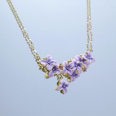 Delicate and Luxurious Lilac Necklace This necklace exudes an air of refinement, luxury, and elegance, as light and graceful as purple clouds. Accented with coordinating light pink gemstones and Czech stones, it embodies the fresh, fragrant atmosphere of spring. Each encounter with the lilac flower is a perfect connection between the soul and nature. Wearing this necklace will fill your heart with happiness and joy. It can also be paired with other pieces from our collection to add more radiance Lilac Necklace, Purple Clouds, Necklace Purple, Purple Necklace, Wonders Of Nature, Necklace Wedding, Pink Gemstones, Chain Jewelry, Art Hand