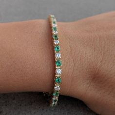 This stunning tennis bracelet features alternating sparkling prong-set diamonds and emeralds, with a box clasp with a figure 8 locking hinge for added security. Available in 14k and 18k yellow, white gold or platinum, just choose desired material from the drop-down menu before checkout. This bracelet is fully customizable. If you prefer different size dimensions, different quality diamonds or moissanites or other colored gemstones, please contact us today to get started on a custom order: http:/ Luxury Emerald Cut Tennis Bracelet As Gift, Luxury Emerald Tennis Bracelet As Gift, Luxury Emerald Tennis Bracelet Gift, Emerald Tennis Bracelet With 17 Jewels For Wedding, Emerald Cut Tennis Bracelet With Prong Setting For Anniversary, Classic Emerald Tennis Bracelet With Jubilee Style, Round Emerald Tennis Bracelet As Gift, Round Emerald Tennis Bracelet Gift, Green Diamond Tennis Bracelet For Formal Occasions