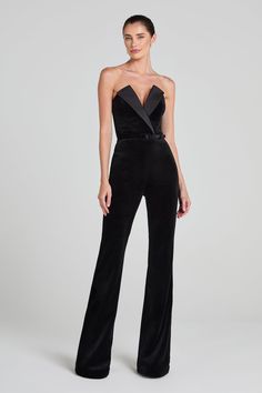 Vivianne Black Jumpsuit Women's Clothing > Jumpsuits. DESCRIPTION &  FEATURES    VIVIANNE is a tuxedo-inspired jumpsuit, crafted from exclusively designed black velvet, with a deep V-neckline. Featuring a structured lapel over the bust, a corseted bodice, our signature fit and flare pant, silhouette-enhancing seam detailing, and functional pockets. Finished with a concealed zip closure and detachable black velvet belt.     Pair it with the      HETTIE Bodysuit    to complete the look.    - Black Nadine Merabi, Structured Corset, Womens Black Jumpsuit, Velvet Belt, Black Velvet Fabric, Corset Boning, Velvet Flares, Flare Jumpsuit, Flare Pant