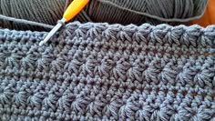 the crochet is being worked on with a needle