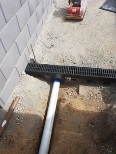 a pipe laying on the ground next to a building