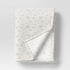 a white blanket with snowflakes on it