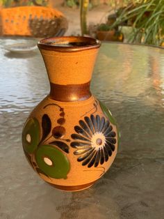 a vase sitting on top of a glass table