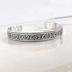 "Details:  - one 3/8\" width solid sterling silver cuff bracelet engraved with a floral motif on the outside - your choice of wording on the inside (175 Characters or less) - your choice of size (6\" is the most common size) - all cuffs can be adjusted with steady pressure to be made tighter or looser ~DON'T FORGET TO GRAB A SUNSHINE POLISHING CLOTH: https://www.etsy.com/listing/469627127/sunshine-cleaning-cloth-for-jewelry?ref=shop_home_active_1 CHECK OUT MY ENTIRE SHOP! https://www.etsy.com/shop/TatumBradleyCo?ref=si_shop" Western Fashion Jewelry, Secret Message Bracelet, Message Bracelet, Cuff Jewelry, Sterling Silver Cuff Bracelet, Personalized Bracelets, Sterling Silver Cuff, The Groom, Silver Cuff Bracelet