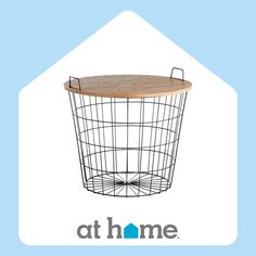 a black wire basket with a wooden top and the words athome on it