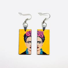 These Frida-inspired earrings are a true work of art, with each element carefully assembled by hand. Made with high quality acrylic paint and protected with a glossy finish, they are not only beautiful but also durable. With their light weight and one-of-a-kind design, they make the perfect gift for someone special. A truly unique accessory for a truly unique person. Size: 3/4 Inch x 1.5 Inch each (without including earrings hook wires).______________________________________ • GET IT FAST!Get it fast! Ready to ship on 1 to 3 business days* • ORDER NOW!Limited Quantities / Limited Edition. • FREE GIFT BOX INCLUDED!Fridamaniacs delivers every jewelry or gift order in a gift box. Thank you for shopping with us!____________________________ * Colors/Designs might slightly vary from actual. Our Artistic Resin Earrings For Pierced Ears, Artistic White Resin Earrings, Artistic Enamel Earrings, Artistic Resin Earrings With Ear Wire, Yellow Earrings With Artistic Design For Gift, Yellow Hand Painted Artsy Earrings, Hand Painted Yellow Artsy Earrings, Artsy Yellow Earrings With Artistic Design, Hand Painted Yellow Enamel Earrings