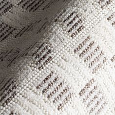 closeup of an upholstered white and brown blanket