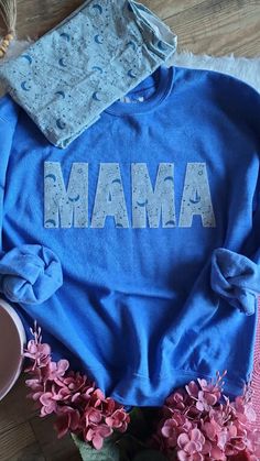 This MAMA sweatshirts is personalized with the clothes of your little one(s  It can be customized to change the name from Nana to any special way the little ones call them like Grandma, Grammy, Mamie, Memaw, Oma and more with the fabric that YOU choose!! You choose what clothing piece you want for each letters.  The fabric is interface to a bonding interfacing and then blanket stitch with a regular sewing machine onto the sweater  These sweatshirts are very comfy and cozy and do RUN BIG, just ke Customizable Family Matching Crew Neck Sweatshirt, Customizable Family Matching Cotton Sweatshirt, Mother's Day Custom Print Crew Neck Sweatshirt, Personalized Blue Cotton Tops, Blue Long Sleeve T-shirt For Gift, Blue Long Sleeve T-shirt As Gift, Blue Custom Print Top For Mother's Day, Blue Crew Neck Sweatshirt With Name Print, Baby Clothes Keepsake