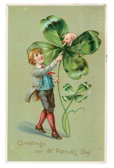 a young boy holding up a four leaf clover with the words greetings on st patrick's day