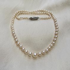 A beautiful graduated pearl necklace, on a vintage silver and marquesite clasp. * 3mm - 6.5mm cultured Akoya pearls * hand knotted on silk * sterling silver safety clasp * 16" necklace length (not your size? Message me.) Lovely quality classic cultured Akoya pearls with a beautiful bright lustre and pink undertones. These pearls are perfectly round and have hardly any flaws in their nacre. I have hand knotted between each of these gorgeous pearls and attached them to a vintage sterling silver, h Vintage Akoya Pearl Drop Necklace, Classic Single Strand Silver Pearl Necklace, Vintage Akoya Pearl Necklace, Vintage Akoya Pearl Necklace For Anniversary, Classic Pearl Necklace With Sterling Silver Clasp For Wedding, Classic Wedding Pearl Necklace With Sterling Silver Clasp, Classic Pearl White Necklace With Sterling Silver Clasp, Unique Pearl Jewelry, Graduated Pearl Necklace