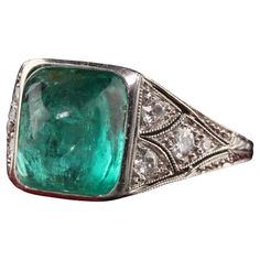 Beautiful Antique Art Deco Platinum Sugar Loaf Emerald Old Euro Diamond Filigree Ring. This incredible Art Deco ring is crafted in platinum and has amazing filigree work on it. The center is a beautiful sugar loaf emerald that is bezel set in an incredible mounting with old european cut diamonds on the sides and profile of the ring. Item #R1205 Metal: Platinum Weight: 5.8 Grams Size: 5 Diamond: Approximately .75 cts Color: H Clarity: VS2 Emerald: Approximately 5 cts Measurements: Top of the ring Vintage Green Diamond Platinum Ring, Vintage Green Diamond Ring In Platinum, Gia Certified Art Deco Platinum Jewelry, Art Deco Green Platinum Jewelry, Vintage Platinum Diamond Ring With Gemstone, Vintage Platinum Ring With Gemstone, Vintage Platinum Gemstone Jewelry, Vintage White Gold Emerald Ring, Vintage White Gold Emerald Jewelry