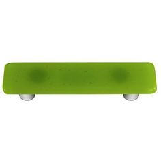 a green skateboard sitting on top of a white wall