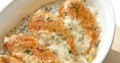 three pieces of chicken covered in cheese and herbs