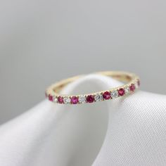 Luxurious alternating Gemstones ringFeaturing Rubies & White Sapphires in an open deck Eternity style ring.Natural Gemstones, hand picked for best color and clarity.Open sided style setting to allow more light and create more sparkle with an Elegant finish.The Gemstones are 1.75mm in DiameterFor Example a Size 7 will have 30 stones and about 0.6 CtwEach ring is perfect in its own way.All item custom made to your specifications by Ardonn.items are Shipped with FedEx/Ups fully insured and trac Fine Jewelry Ruby Eternity Band Round Cut, Ruby Round Cut Eternity Band, Ruby Half Eternity Round Ring In Fine Jewelry Style, Ruby Half Eternity Ring With Diamond In Round Band, Ruby Diamond Ring With Half Eternity Round Band, Fine Jewelry Ruby Ring With Half Eternity Band, Ruby Rings With Half Eternity Round Band, Ruby Half Eternity Ring With Round Band, Half Eternity Ruby Rings