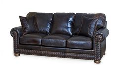 a brown leather couch with studding on the arms