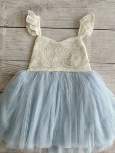 ♥ Product Information 100% Cotton in bodice and lining 100 % polyester tulle skirt Do not bleach Color is a Off White for the top and light blue for the tutu   This little girls party dress is perfect for any occasion, whether it would be for weddings flower girls dress, birthdays dress, Christmas gift, Easter dress, play wear and etc! Toddler tutu dress 's elastic back has a small loop to tie the strap crossover, adjust the length accordingly for a comfortable fit Beautiful baby dress has 4 layers exquisite fine tulle on the skirt with cotton lining to protect toddler girls gentle skin; Double layer front bodice with sweat heart front neck ;super full tutu is sure to make her stand out in a crowd Please measure chest and waist for a better fit, thank you so much for your understanding and Spring Princess Dress With Lace Bodice And Tulle, Light Blue Tutu Dress For Summer Dress-up, Spring Tutu Dress With Lace Bodice And Tulle Material, Spring Tutu Dress With Lace Bodice For Dress-up, Summer Lace Tutu Dress For Dress-up, Princess Style Tutu Dress With Lace Bodice, Light Blue Ruffled Tutu Dress For Baptism, Princess Style Ruffled Dress For Cake Smash, Fitted Tulle Princess Dress With Lace Trim