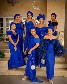 the beautiful ladies in blue dresses are posing for a photo on steps with one another