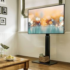 a flat screen tv sitting on top of a wooden table