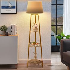 a lamp that is sitting on top of a stand in a living room next to a couch