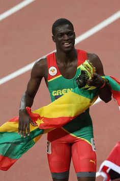 a man holding a flag on top of a track