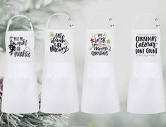 three white aprons hanging from a christmas tree with the words, not all who wander are