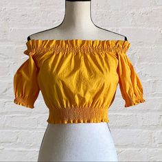 H&M Yellow Cropped Off Shoulder Ruffled Blouse Boho Style Top In Woven Cotton Fabric With Eyelet Embroidery. Short Sleeves With Smocked Trim And Smocking At Top And At Hem. Nwt Elastic Stretch Measurements Chest 15” Bust 30” Length 15” Discounts Offered On Bundles Of 2+ Posh Ambassador- Suggested User Fast Shipping Top Rated - 5 Seller Chic Yellow Off-shoulder Tops, Yellow Fitted Off-shoulder Tops, Casual Yellow Off-shoulder Top, Fitted Off-shoulder Yellow Tops, Yellow Ruffled Top For Brunch, Chic Yellow Short Sleeve Crop Top, Chic Mustard Tops For Spring, Yellow Short Sleeve Summer Crop Top, Chic Yellow Cotton Crop Top