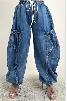 These Relaxed Cargo Denim Pants blend comfort with functionality, featuring a loose, relaxed fit that is perfect for a casual yet stylish look. Crafted from high-quality denim, these pants boast a unique design with multiple pockets and drawstring details at the waist and ankles, offering both practicality and a touch of edgy flair. The distressed stitching and oversized silhouette make these pants a standout piece, ideal for pairing with a variety of tops for a versatile outfit. Model wearing s Cargo Denim Pants, Denim Scraps, Diy Jacket, Balloon Pants, Denim Day, Classy Casual Outfits, Classy Casual, Versatile Outfits, Oversized Silhouette