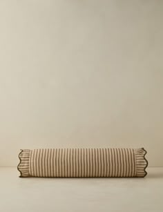 a striped pillow sitting on top of a white table