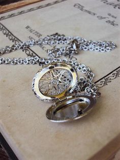 This is a beautiful vintage oval locket necklace. The locket has ornate openwork filigree on the front, with a starburst design in the middle, and a textured design on the back. It is silver plate, with a great antique silver hue. The chain is 18 in. long, and is a textured link design. The locket is 1 in. long including the bail, and 3/4 in. wide. The necklace is in great new unused condition, and is a nice style for layering with more chains! Thank you for looking! Vintage Round Compass Jewelry, Vintage Oval Pendant Charm Necklace As Gift, Vintage Oval Pendant Charm Necklace, Vintage Oval Pendant Charm Necklace For Gift, Vintage Silver Jewelry With Compass Design, Vintage Round Compass Pendant Jewelry, Metal Oval Locket Necklace, Vintage Silver Compass Design Jewelry, Oval Metal Locket Necklace