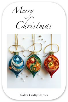 three christmas ornaments hanging from strings with the words merry christmas written on them in gold lettering