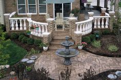 an aerial view of a house with a fountain in the front yard