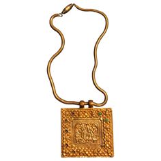 A gilt bronze necklace with chain and a square plaque on the subject of "Adam and Eve in the Garden of Eden" with apple tree in the center, designed and made by Line Vautrin in her early career circa 1938/39. This piece is likely to be cast from the original mold with its sharp and clear lines, when closely compared to the casting published on page 29 of the book Line Vautrin: Sculptor, Jeweler, Magician by Line Vautrin and Patrick Mauries; Thames and Hudson. The chain is also identical to the p Line Vautrin Jewelry, Bird Aesthetic, Necklaces Beautiful, Line Vautrin, Bronze Dragon, Beautiful Pendants, Bronze Bracelets, The Garden Of Eden, French Jewelry