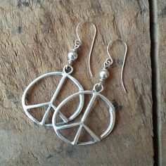 Organic antique silver peace signs are wire wrapped to sterling silver hooks. You can choose either simple silver or turquoise colored beads as an embellishment. The peace signs are 1 1/2 inches. Hanging from the earwire, the total length is 2 1/2 inches. I will include silicone ear backs so you won't have to be worried about losing one. All items are wrapped in brown tissue and tied up in a brown Kraft pillow box ready for giving away or for you to enjoy yourself. Hippie Sterling Silver Nickel-free Jewelry, Nickel-free Sterling Silver Hippie Jewelry, Hippie Style Sterling Silver Nickel-free Jewelry, Silver Hippie Dangle Jewelry, Hippie Silver Dangle Jewelry, Bohemian Nickel-free Silver-plated Wire Earrings, Bohemian Silver Plated Nickel-free Jewelry, Bohemian Nickel-free Silver-plated Jewelry, Adjustable Nickel-free Silver-plated Earrings