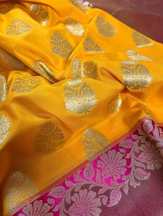 Beautiful Mango Yellow Banarasi Handloom Saree with Pink Border with Floral Patterns with Wide Border Cooper Zari used in Border and Pallu. Item : SareeColor : Mango Yellow and Pink Base Fabric : Banarasi Silk (Non-Pure) Blouse piece : Comes with Blouse pieceBlouse material : Banarasi Silk (Non-Pure) Fall & Edging: Comes with Fall and edging (Pico) and tassels attached Disclaimer -:- Color variation is possible due to various reasons like phone or desktop setting, resolution etc. Please don't ho Brocade Traditional Wear For Puja During Diwali, Brocade Saree With Self Design For Puja, Puja Brocade Saree With Pallu, Brocade Saree With Cutdana For Puja, Brocade Saree With Pallu For Puja, Yellow Handloom Sets For Festivals, Semi-stitched Yellow Brocade Traditional Wear, Festive Yellow Brocade Saree, Handloom Brocade Saree For Puja