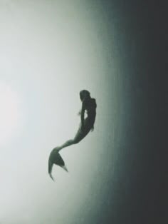 the silhouette of a person jumping in the air