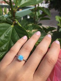 A delicate and beautifully crafted lab created light blue opal ring.Or New White opal This beautiful and feminine ring for her is set in sterling silver with halo micro CZ stones all the way around. We use the finest AAA quality micro CZ's on each side of the band and all the way around framing the brilliant sparkly opal. This ring makes for a gorgeous alternate engagement ring, a promise ring or just an everyday pretty ring for yourself! Your ring is cast with the purest 925 Sterling silver and Blue Opal Promise Ring, Opal Halo Jewelry As Gift, Dainty Blue Opal Ring For Gift, Opal Ring With Halo Design For Gift, Blue Opal Ring As A Gift, Blue Opal Rings For Anniversary, Blue Opal Ring For Gift, Fine Jewelry Style, Blue Opal Ring Fine Jewelry Gift, Blue Opal Ring For Gift In Fine Jewelry Style