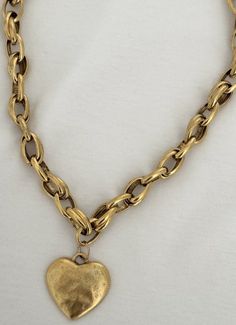 Gold-tone Heart Necklace With Adjustable Chain, Gold-tone Heart Pendant Necklace With Adjustable Chain, Metal Heart Charm Choker Necklace, Elegant Heart-shaped Brass Necklace, Heart-shaped Gold-tone Jewelry, Elegant Brass Heart Necklace, Gold Necklace With Heart Pendant And Charm, Gold-tone Necklace For Valentine's Day, Gold Choker Necklace With Heart Charm