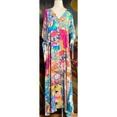 New With Tags Size Small This Gorgeous Maxi Dress By Johnny Was Has A Breezy Bohemian Look. The Long Dress Has A Floral & Mosaic Patchwork Pattern. It Has Three Quarter Sleeves That Have Romantic Ties. This Dress Has A Flattering V-Neck With Buttons Down The Bodice. It Has A Tiered Loose Dropwaist. The Beautiful Dress Is Unlined & Does Not Come With A Slip. It Has Pockets! Measurements Laying Flat: Length 56 1/4” Bust 18 1/4” Waist 18.5” Hips 20” Vibrant Multicolor V-neck Dress, Pink Vibrant Print Dress For Beach Cover-up, Colorful Floral Print Beach Cover-up Dress, Multicolor Vibrant Print Beachwear Dress, Vibrant Tropical Print Multicolor Dress, Vibrant Multicolor Tropical Print Dress, Vibrant Floral Print Maxi Dress, Vibrant Multicolor Maxi Dress Beach Cover-up, Colorful Printed Beachwear Dresses