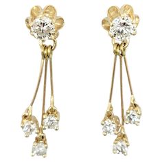 These versatile, sparkling diamond earrings can be worn two ways for double the glamour! A stunning round solitaire diamond set in a flower shaped yellow gold setting acts as a simple stud earring for everyday wear. To dress it up, the dangling triple diamond drops can be easily slipped on to the post, giving movement and additional sparkle to these beauties. These are sure to become one of your new favorite pairs! Earring type: Stud / Drop Metal: 14 Karat Yellow Gold Natural Diamonds: 2.05 ctw Beautiful Stud Earrings, Diamond Earrings Studs Round, Simple Stud Earrings, Round Solitaire, Stud Style, Sparkling Diamond, Yellow Gold Setting, Solitaire Diamond, Round Stud Earrings