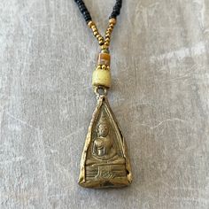 This one-of-a-kind vintage brass Buddha pendant has a unique beaded necklace. M Hand strung on 7 strand wire with a lobster clasp. This necklace hangs 11 inches from clasp to bottom of pendant. Adjustable Beaded Necklace With Teardrop Pendant, Gold Teardrop Beaded Necklaces With Dangling Beads, Bohemian Adjustable Beaded Necklace With Teardrop Pendant, Gold Teardrop Beaded Necklace With Dangling Beads, Adjustable Bohemian Beaded Necklace With Teardrop Pendant, Spiritual Necklaces With Dangling Beads, Festival Beaded Brass Necklace, Festival Brass Beaded Necklace, Vintage Handmade Dangle Beaded Necklaces