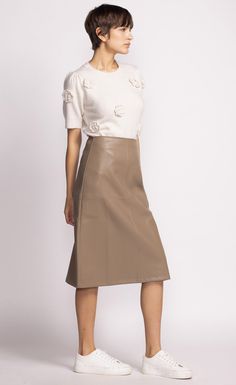 The Peyton Skirt is a chic mid-length faux leather piece that adds a touch of sophistication to any outfit. Style it with a tucked-in blouse and heels for a polished look! Material: 55% PU, 45% Polyester Tapered panel detail Back zip closure Model is wearing XS Vegan Leather Skirt, Pink Martini, Swimsuit With Shorts, Leather Skirts, Thick Heel, Swimsuit Dress, Leather Pieces, Dress Gift, Sweater Sale