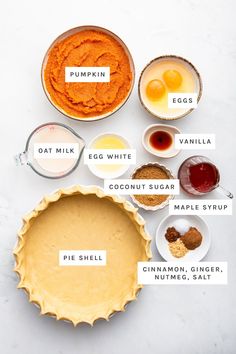 ingredients for pumpkin pie laid out in bowls on a white surface with the names below