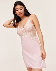 Our lovely and romantic Raquel slip dress is unlined, has adjustable ties in the back, and is made from sheer georgette and lace in a beautiful bright white. It's the perfect lingerie to add some romance to your night. (Available in sizes XS-XL.) Feminine Summer Camisole With Lace Bodice, Spaghetti Strap Lace Trim Dress For Wedding Night, Delicate Lace Fitted Camisole, Delicate Fitted Lace Camisole, Fitted Delicate Lace Camisole, Feminine Lace Nightgown For Wedding Night, Pink Sheer Camisole Dress, Lace Dress With Spaghetti Straps For Wedding Night, Spring Lace Backless Slip Dress