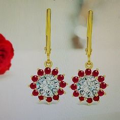 Brand New, Unused, Dainty Moissanite And Genuine Ruby Dangle Earrings. Set In 14k Yellow Gold. Moissanite Is The Center Stone Surrounded By Beautiful Genuine Rubies For A 2.15 Ctw. Moissanite Has A Higher Dispersion Value (Fire) Than Diamond, Making It Sparkle Like Crazy. Each Lab Created Gem Is Faceted By A Skilled Cutter To Maximize Its Brilliance And Enhance Its Exceptional Fire. Second In Hardness Only To Diamond, It Is Extremely Resistant To Scratching, Abrasion And Chipping. Stamped 14k. Classic Red Diamond Earrings As Gift, Red Diamond Earrings As A Gift, Red Earrings For Anniversary, Red Diamond Earrings For Gifts, Red Diamond Earrings For Wedding, Red Round Diamond Earrings For Formal Events, Red Diamond Drop Earrings For Formal Events, Red Halo Design Earrings For Wedding, Red Diamond Earrings With Prong Setting As Gift