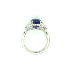 A stunning 4.53 carat cushion shape blue sapphire with exquisite "royal blue" color is set with two spectacular diamonds in this handmade platinum 3-stone engagement ring. Gemstones like this are in a class by themselves. With its deep blue color, exceptional clarity and excellent proportions, sapphires of this caliber are rare and highly sought after, even by gem dealers. This cushion measures 9.17 x 8.68 x 6.39mm is accompanied by Gemological Institute of America Origin Report #2205170372 whic Blue Radiant Cut Three-stone Ring, Three Stone Sapphire Ring With Radiant Cut Diamond, Blue Sapphire Ring With Three Stones, Blue Three Stone Platinum Jewelry, Blue Sapphire Ring In Radiant Cut Platinum, Blue Three-stone Cushion-cut Jewelry, Blue Three-stone Cushion Cut Jewelry, Three Stone Radiant Cut Sapphire Ring, Fine Jewelry Tanzanite Three Stone Sapphire Ring